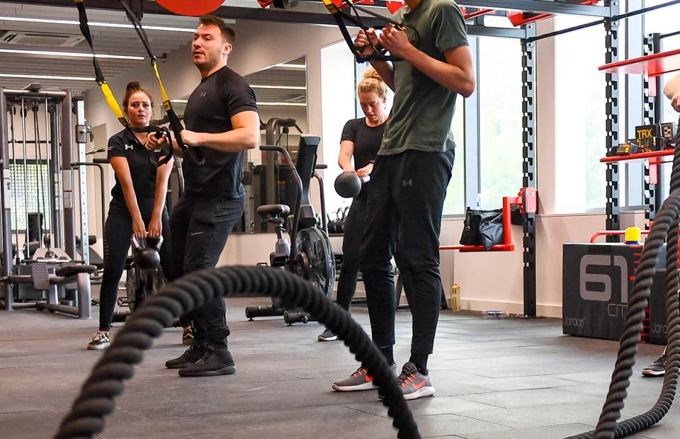 A group of people doing weight exercises at the Solent gym